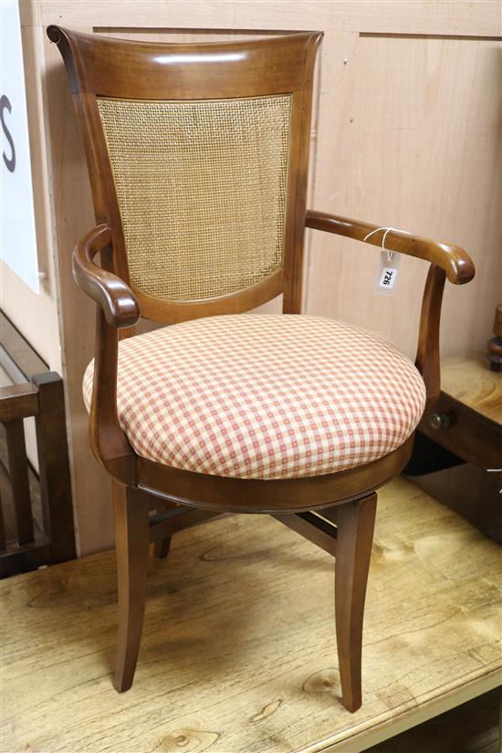A revolving caned chair